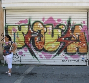 Woman Matches Graffiti on Garage